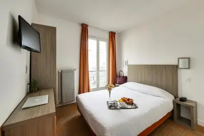 Un ou plusieurs lits dans un hébergement de l'établissement Louisa Hotel Paris