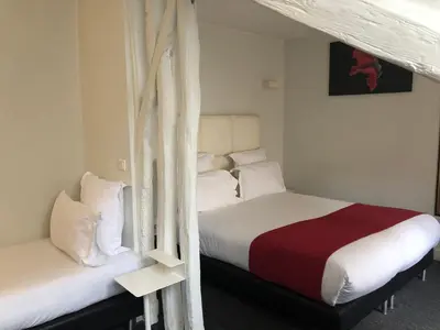 Un ou plusieurs lits dans un hébergement de l'établissement Hôtel Lecourbe, Paris Tour Eiffel