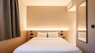 Un ou plusieurs lits dans un hébergement de l'établissement Kyriad ECO - Suresnes - La Defense