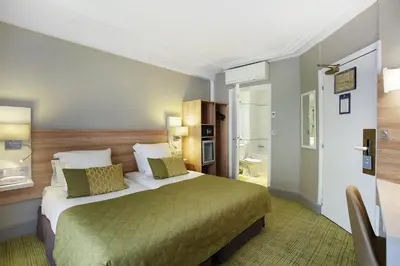 Un ou plusieurs lits dans un hébergement de l'établissement Hotel Lautrec Opera