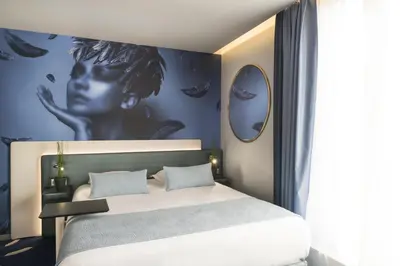 Un ou plusieurs lits dans un hébergement de l'établissement Le Bon Hôtel