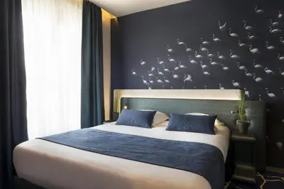 Un ou plusieurs lits dans un hébergement de l'établissement Le Bon Hôtel