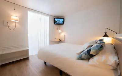 Un ou plusieurs lits dans un hébergement de l'établissement Hotel Little Regina