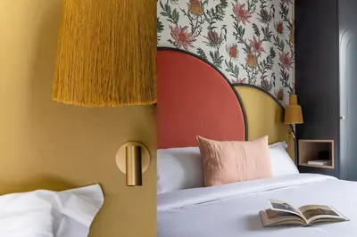 Un ou plusieurs lits dans un hébergement de l'établissement Hôtel Léopold - Orso Hotels