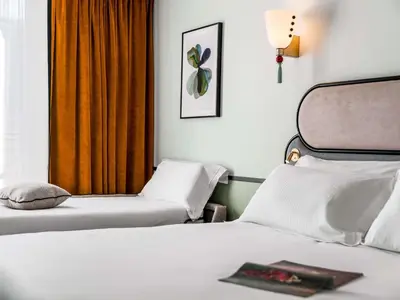 Un ou plusieurs lits dans un hébergement de l'établissement Hotel Faubourg Galant Paris - Handwritten Collection