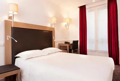 Un ou plusieurs lits dans un hébergement de l'établissement Hôtel Elysées Flaubert