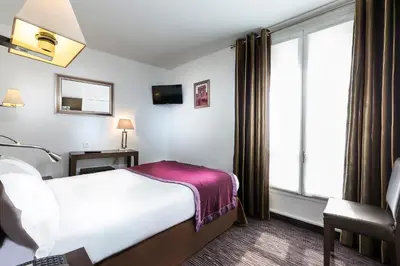 Un ou plusieurs lits dans un hébergement de l'établissement Hôtel Elysées Flaubert