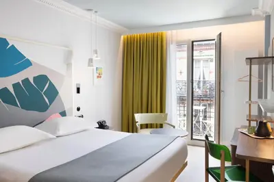 Un ou plusieurs lits dans un hébergement de l'établissement Hôtel De La Paix