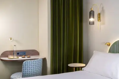 Un ou plusieurs lits dans un hébergement de l'établissement Hotel L de Lutece - Notre-Dame