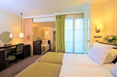 Un ou plusieurs lits dans un hébergement de l'établissement Hôtel Henri IV Rive Gauche