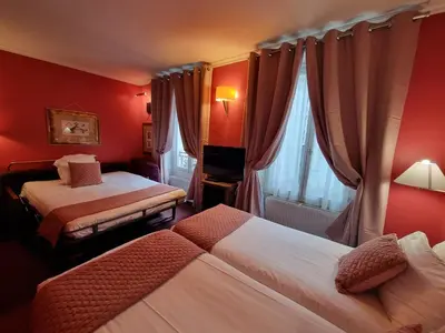 Un ou plusieurs lits dans un hébergement de l'établissement Hôtel France Eiffel