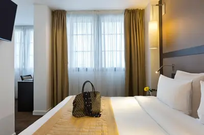 Un ou plusieurs lits dans un hébergement de l'établissement Simon's Boutique Hôtel