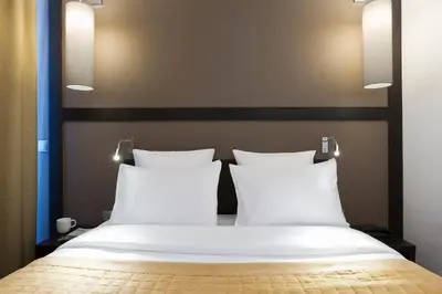 Un ou plusieurs lits dans un hébergement de l'établissement Simon's Boutique Hôtel