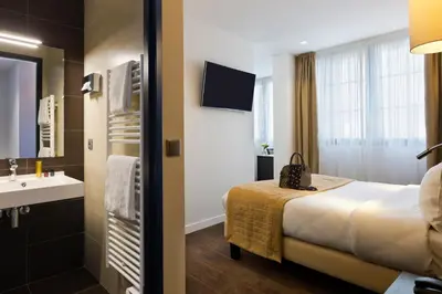 Un ou plusieurs lits dans un hébergement de l'établissement Simon's Boutique Hôtel