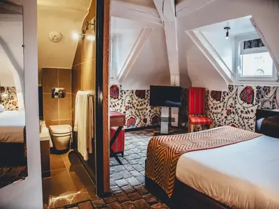 Un ou plusieurs lits dans un hébergement de l'établissement Hotel Le Notre Dame Saint Michel
