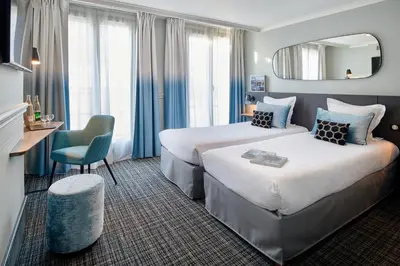 Un ou plusieurs lits dans un hébergement de l'établissement Hotel Vacances Bleues Provinces Opera