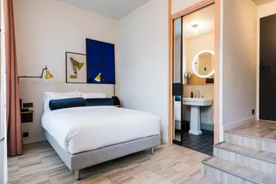 Un ou plusieurs lits dans un hébergement de l'établissement Le Grand Quartier