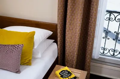 Un ou plusieurs lits dans un hébergement de l'établissement Grand Hotel des Balcons