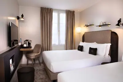 Un ou plusieurs lits dans un hébergement de l'établissement Hôtel Eiffel Saint Charles
