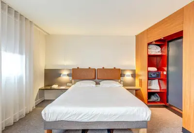 Un ou plusieurs lits dans un hébergement de l'établissement B&B HOME Paris Nord 18ème