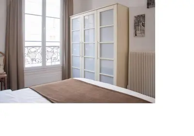 Un ou plusieurs lits dans un hébergement de l'établissement La petite maison parisienne