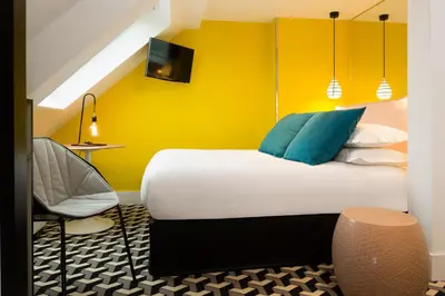 Un ou plusieurs lits dans un hébergement de l'établissement Hotel Haussmann Saint Augustin