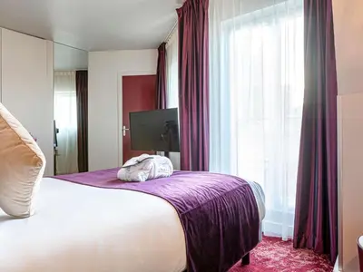 Un ou plusieurs lits dans un hébergement de l'établissement Mercure Paris Place d'Italie