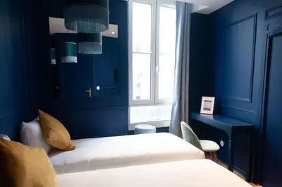 Un ou plusieurs lits dans un hébergement de l'établissement Hôtel Petit Saint-Honoré