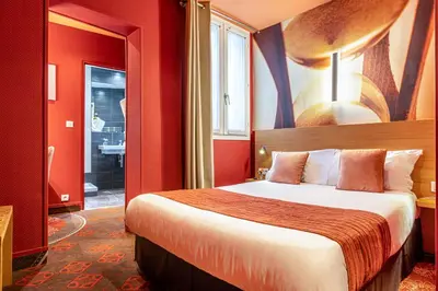 Un ou plusieurs lits dans un hébergement de l'établissement Hotel Ariane Montparnasse by Patrick Hayat