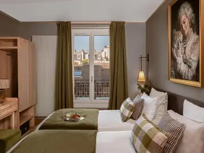 Un ou plusieurs lits dans un hébergement de l'établissement Hôtel Zélie Champs-Elysées