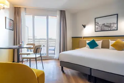 Un ou plusieurs lits dans un hébergement de l'établissement Aparthotel Adagio Paris Montrouge