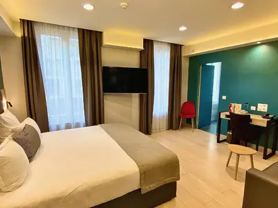 Un ou plusieurs lits dans un hébergement de l'établissement Grand Hôtel Clichy Paris