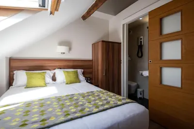 Un ou plusieurs lits dans un hébergement de l'établissement Hotel Chabrol Opera