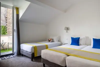 Un ou plusieurs lits dans un hébergement de l'établissement Hotel George - Astotel