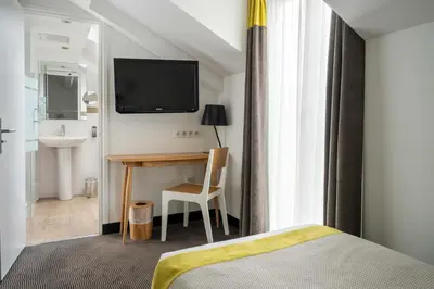 Un ou plusieurs lits dans un hébergement de l'établissement Hotel George - Astotel