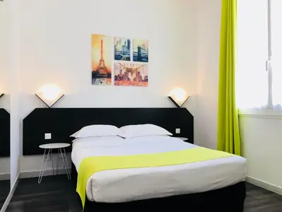 Un ou plusieurs lits dans un hébergement de l'établissement Boulogne Résidence Hotel