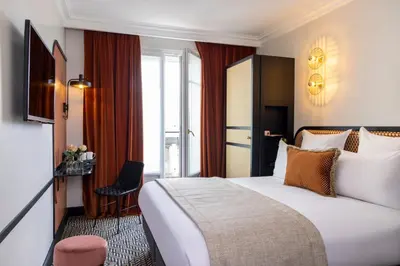 Un ou plusieurs lits dans un hébergement de l'établissement Grand Hôtel Chicago