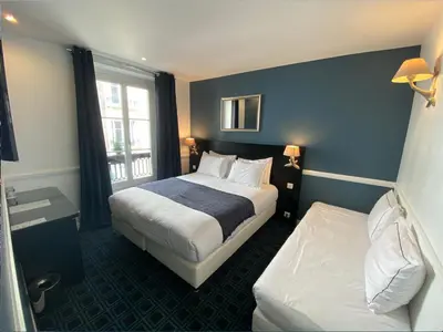 Un ou plusieurs lits dans un hébergement de l'établissement Hôtel Etoile Trocadéro