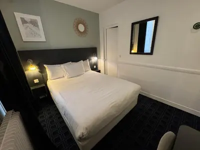 Un ou plusieurs lits dans un hébergement de l'établissement Hôtel Etoile Trocadéro