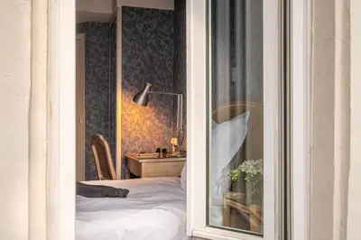 Un ou plusieurs lits dans un hébergement de l'établissement Hôtel Baudelaire Opéra