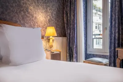 Un ou plusieurs lits dans un hébergement de l'établissement Hôtel Baudelaire Opéra