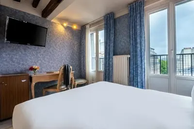 Un ou plusieurs lits dans un hébergement de l'établissement Hôtel Baudelaire Opéra
