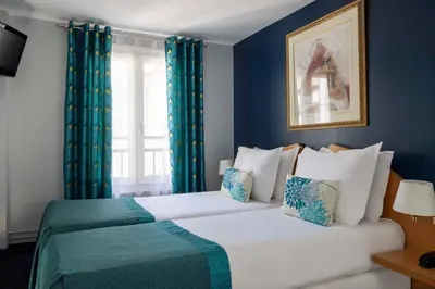 Un ou plusieurs lits dans un hébergement de l'établissement Grand Hotel du Calvados - Opera
