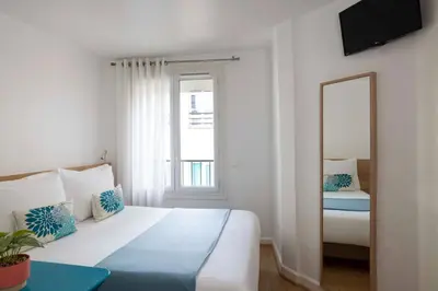 Un ou plusieurs lits dans un hébergement de l'établissement Grand Hotel du Calvados - Opera