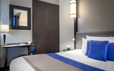 Un ou plusieurs lits dans un hébergement de l'établissement Hôtel Le Marquis by Inwood Hotels