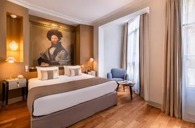 Un ou plusieurs lits dans un hébergement de l'établissement Hôtel Le Walt by Inwood Hotels