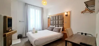 Un ou plusieurs lits dans un hébergement de l'établissement Hotel de France 18