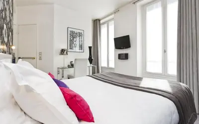 Un ou plusieurs lits dans un hébergement de l'établissement Hôtel Soft