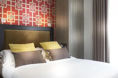 Un ou plusieurs lits dans un hébergement de l'établissement Hôtel International Paris
