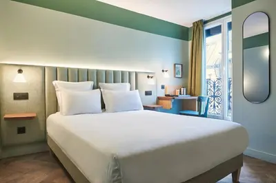 Un ou plusieurs lits dans un hébergement de l'établissement Hotel 10 Opéra by HappyCulture